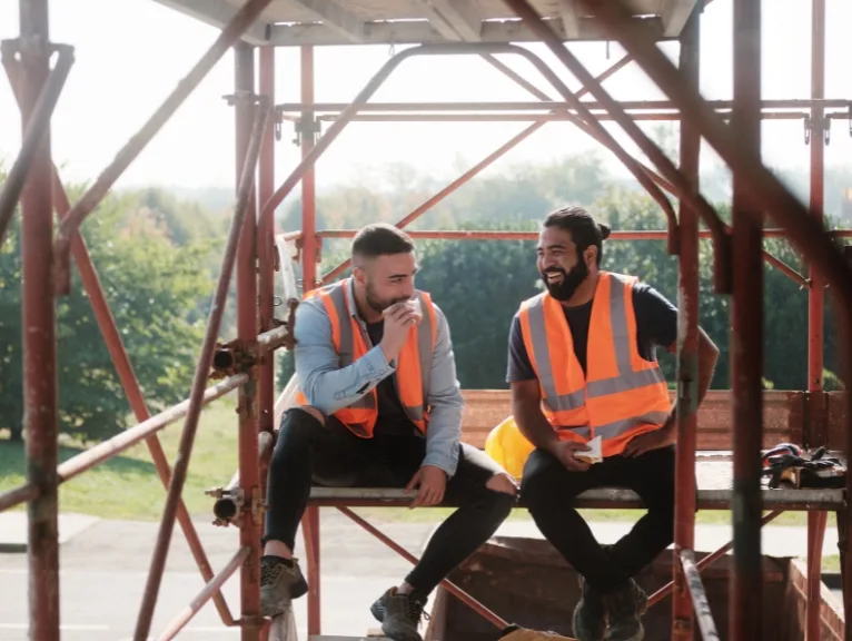 Two construction workers enjoying their lunch